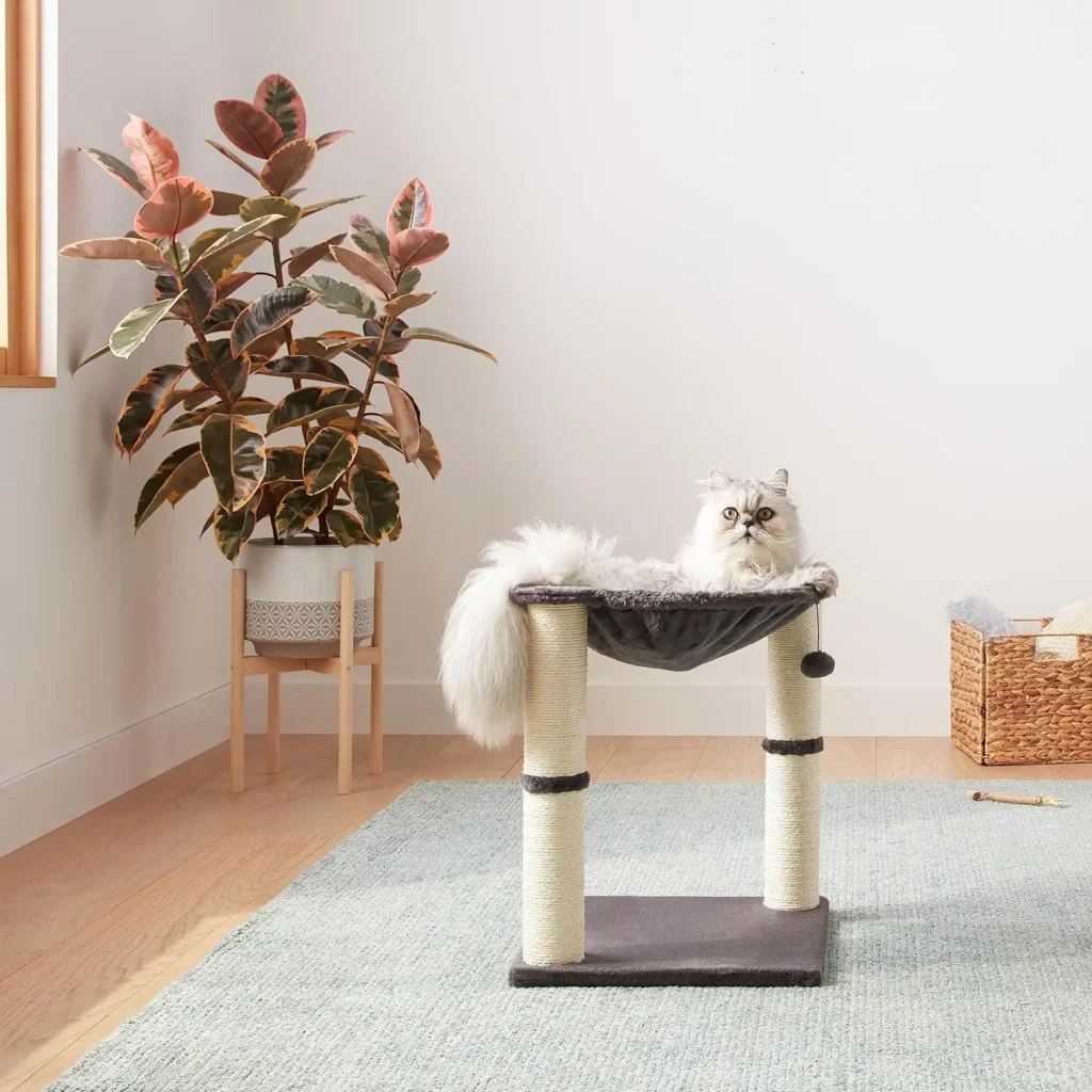 white cute cat lying down in a cat tower gifts for cats